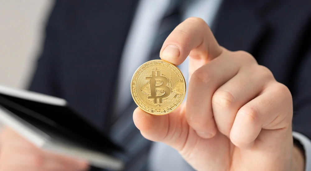 arabic businessman holding a bitcoin close up